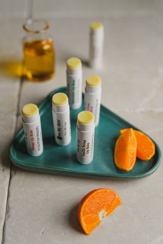 giant 1/2 oz Lip balm. 6 lip balm flavors displayed on a green tray